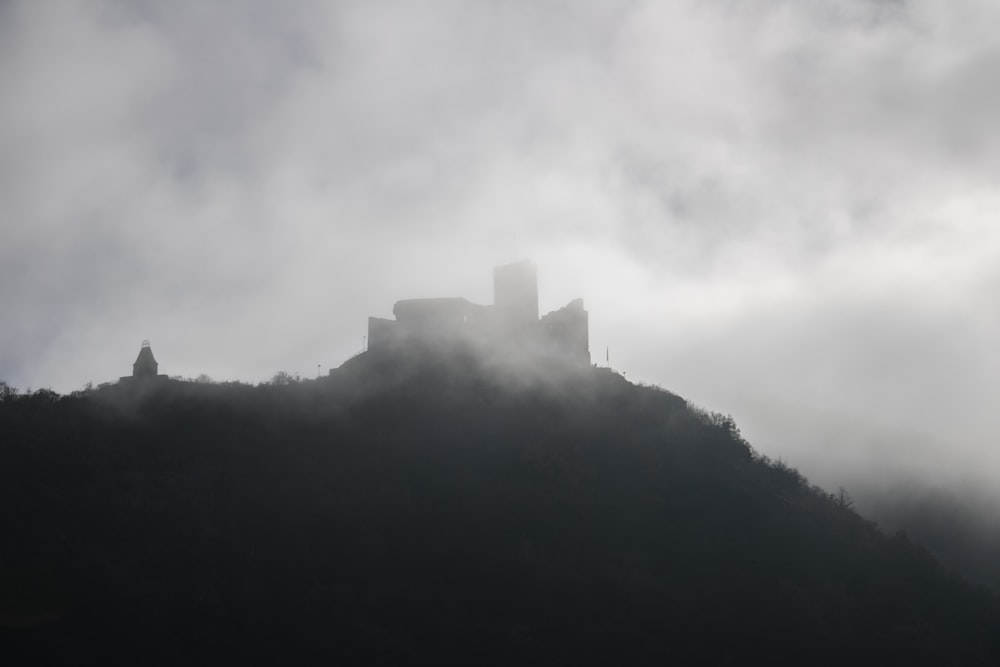 a castle on top of a hill in the fog