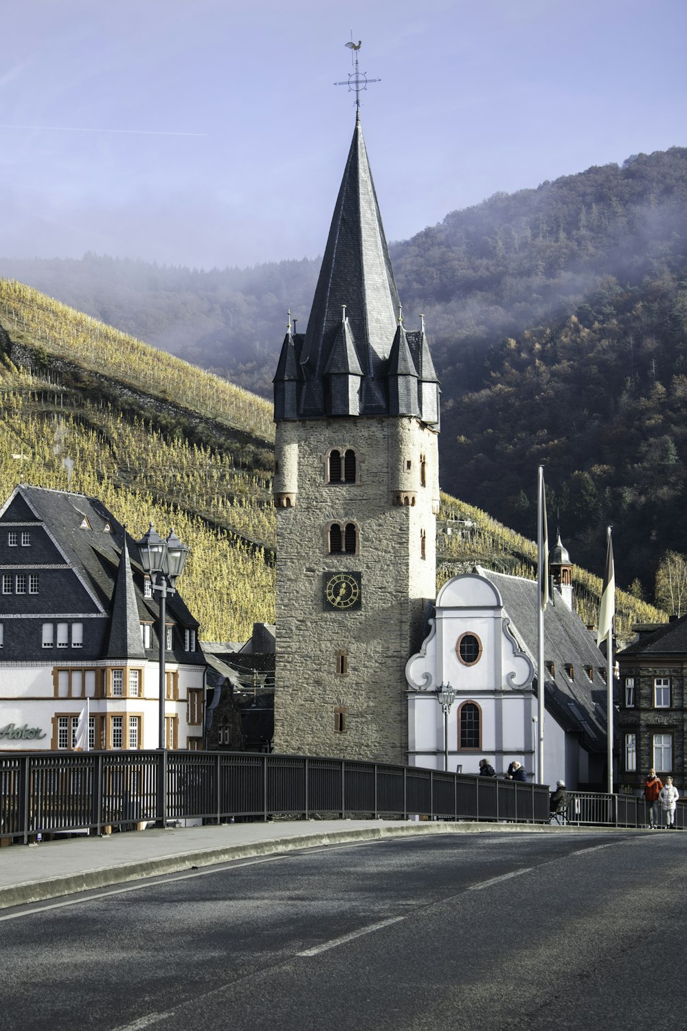 a church on the side of a road with a mountain in the background