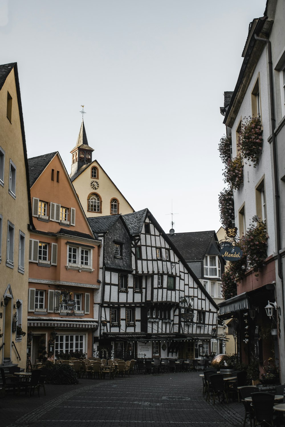 a cobblestone street lined with tall buildings