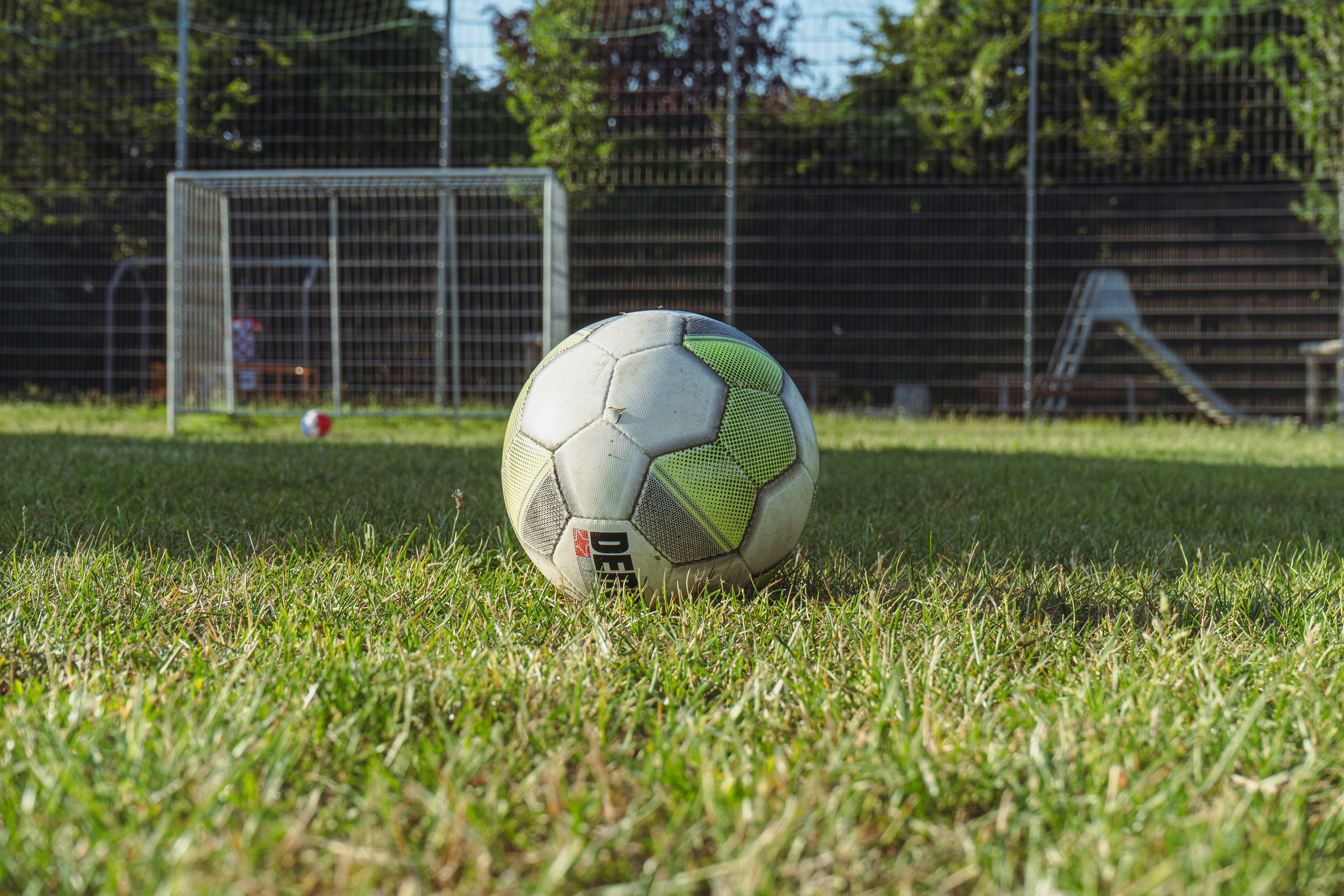 a soccer ball sitting on top of a lush green field