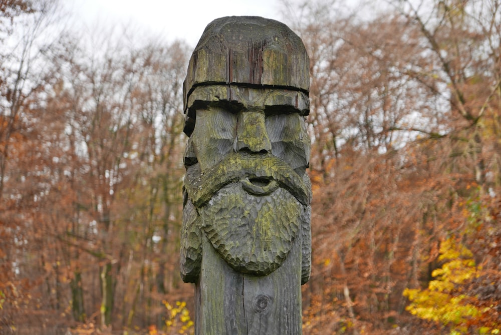 a wooden carving of a man with a beard