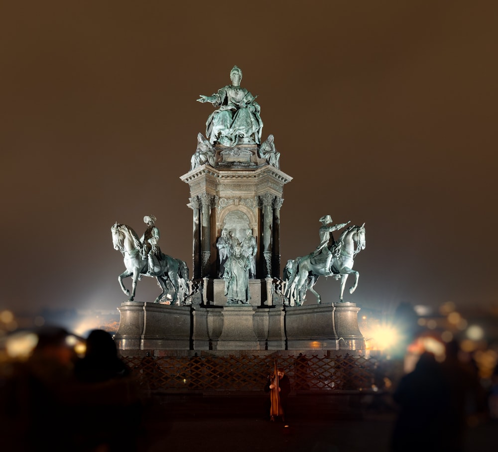 a group of people standing around a statue