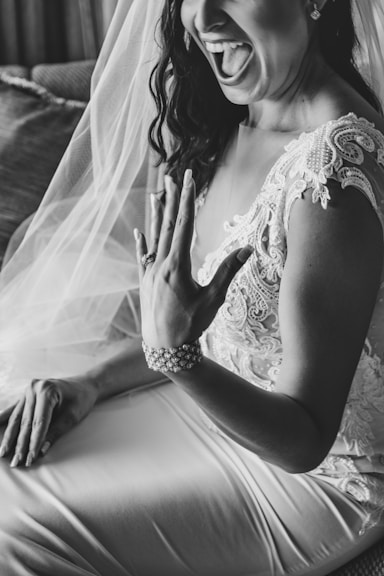 a woman in a wedding dress sitting on a couch
