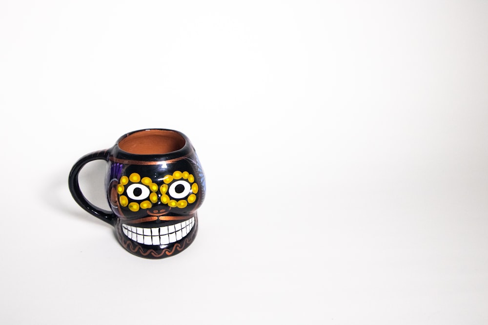 a coffee mug with a painted skull on it