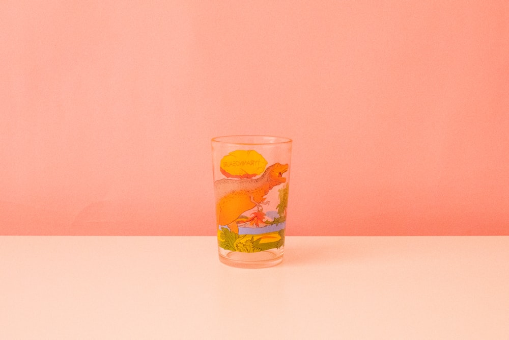 a glass of orange juice on a table