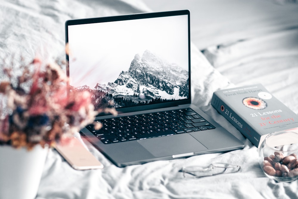 a laptop computer sitting on top of a bed