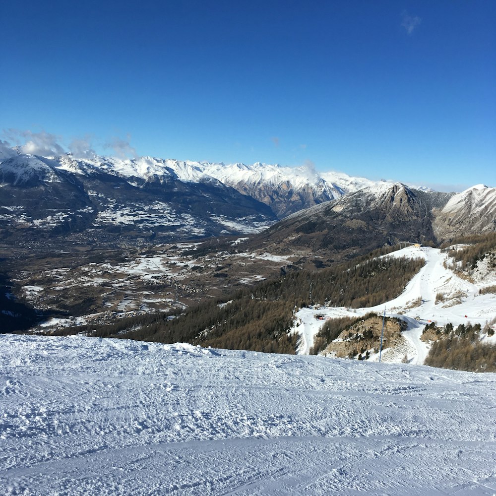 a person standing on top of a snow covered slope