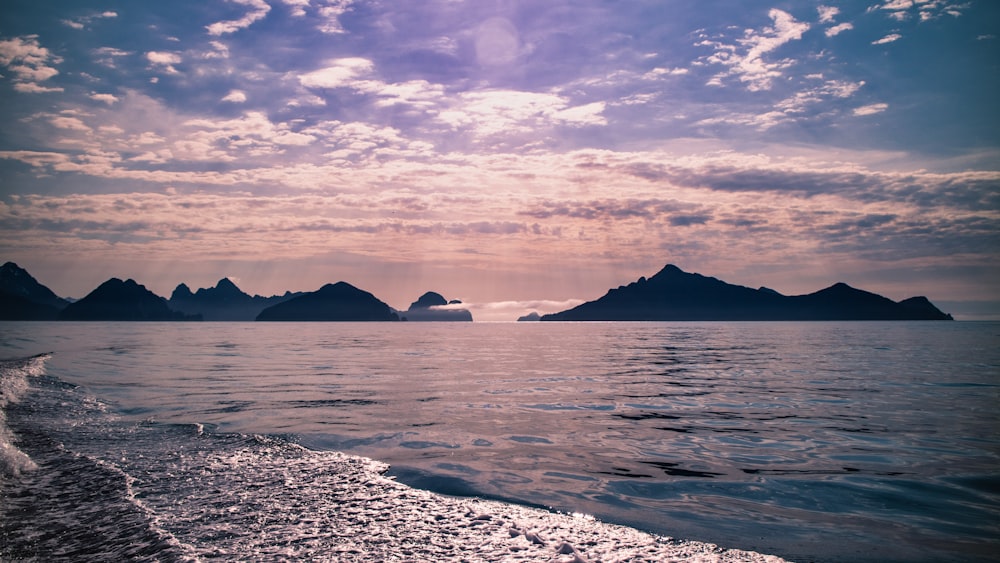 a view of a body of water with mountains in the background