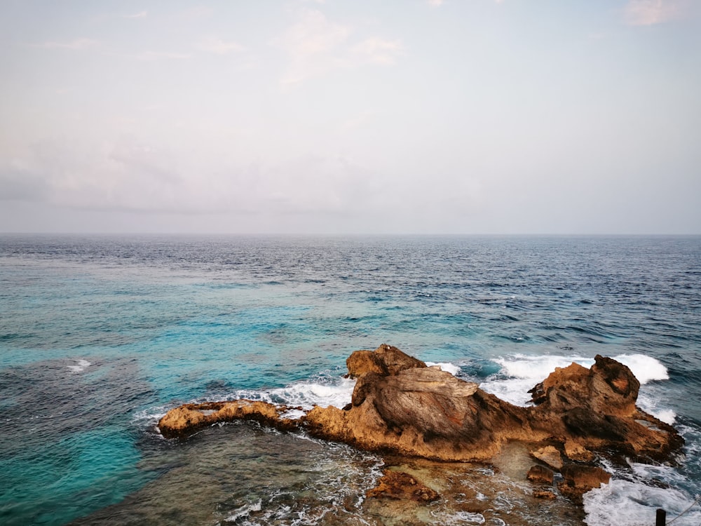 a rocky outcropping in the middle of the ocean