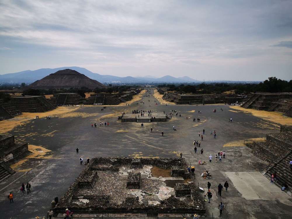 a group of people walking around an ancient city