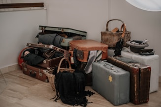 a pile of luggage sitting on top of a hard wood floor