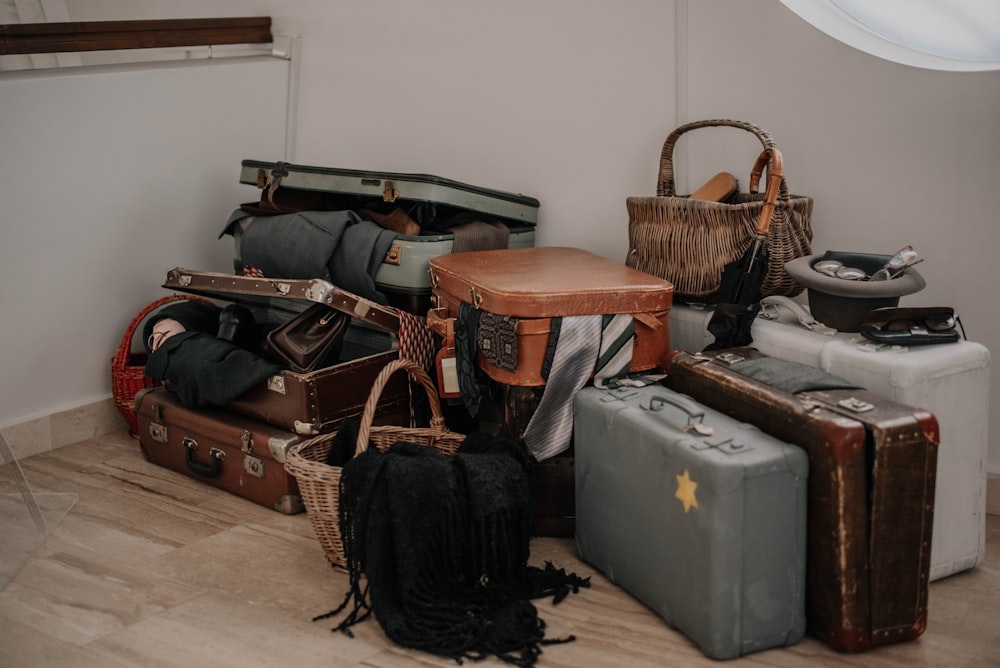 a pile of luggage sitting on top of a hard wood floor