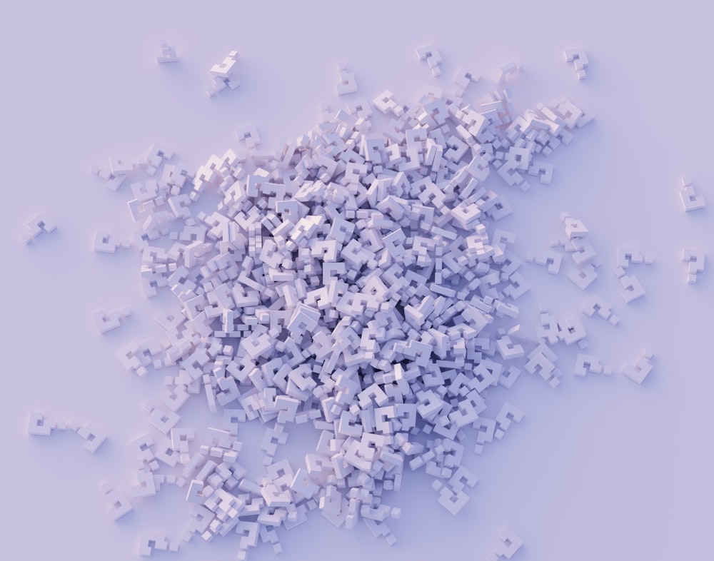 a pile of small white objects on a white surface