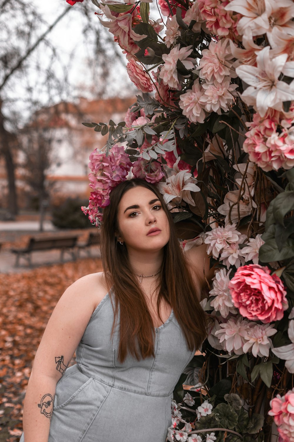 a woman standing next to a tree covered in flowers