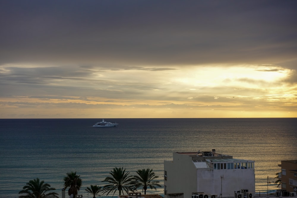 a boat is out in the ocean on a cloudy day