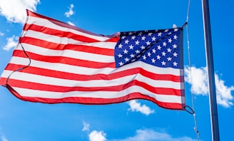 an american flag waving in the wind on a sunny day