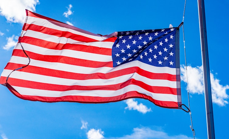 an american flag waving in the wind on a sunny day