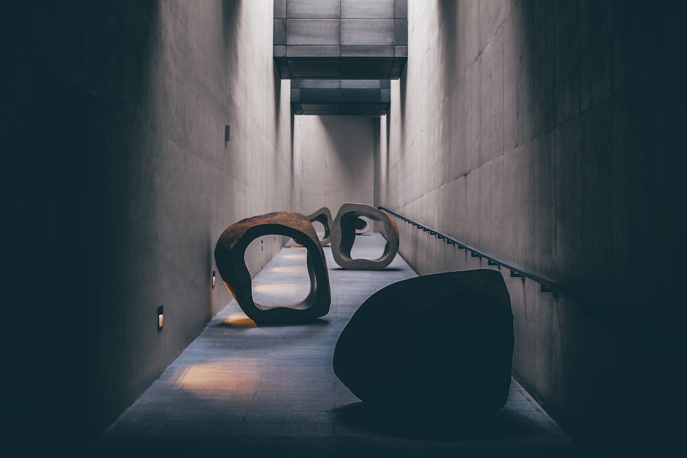 a couple of large sculptures sitting on top of a cement floor