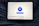 A tablet displaying a VPN application interface with a white background. The screen shows a large blue button labeled 'Disconnect' in the center, surrounded by circular lines. Below, there are several country flag icons representing different server locations, including Netherlands, Germany, Canada, Singapore, India, New York, and San Francisco. The tablet is resting on a person's lap, wearing blue jeans.