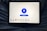 A tablet displaying a VPN application interface with a white background. The screen shows a large blue button labeled 'Disconnect' in the center, surrounded by circular lines. Below, there are several country flag icons representing different server locations, including Netherlands, Germany, Canada, Singapore, India, New York, and San Francisco. The tablet is resting on a person's lap, wearing blue jeans.