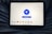 A tablet displaying a VPN application interface with a white background. The screen shows a large blue button labeled 'Disconnect' in the center, surrounded by circular lines. Below, there are several country flag icons representing different server locations, including Netherlands, Germany, Canada, Singapore, India, New York, and San Francisco. The tablet is resting on a person's lap, wearing blue jeans.
