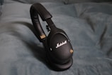 a close up of a pair of headphones on a bed