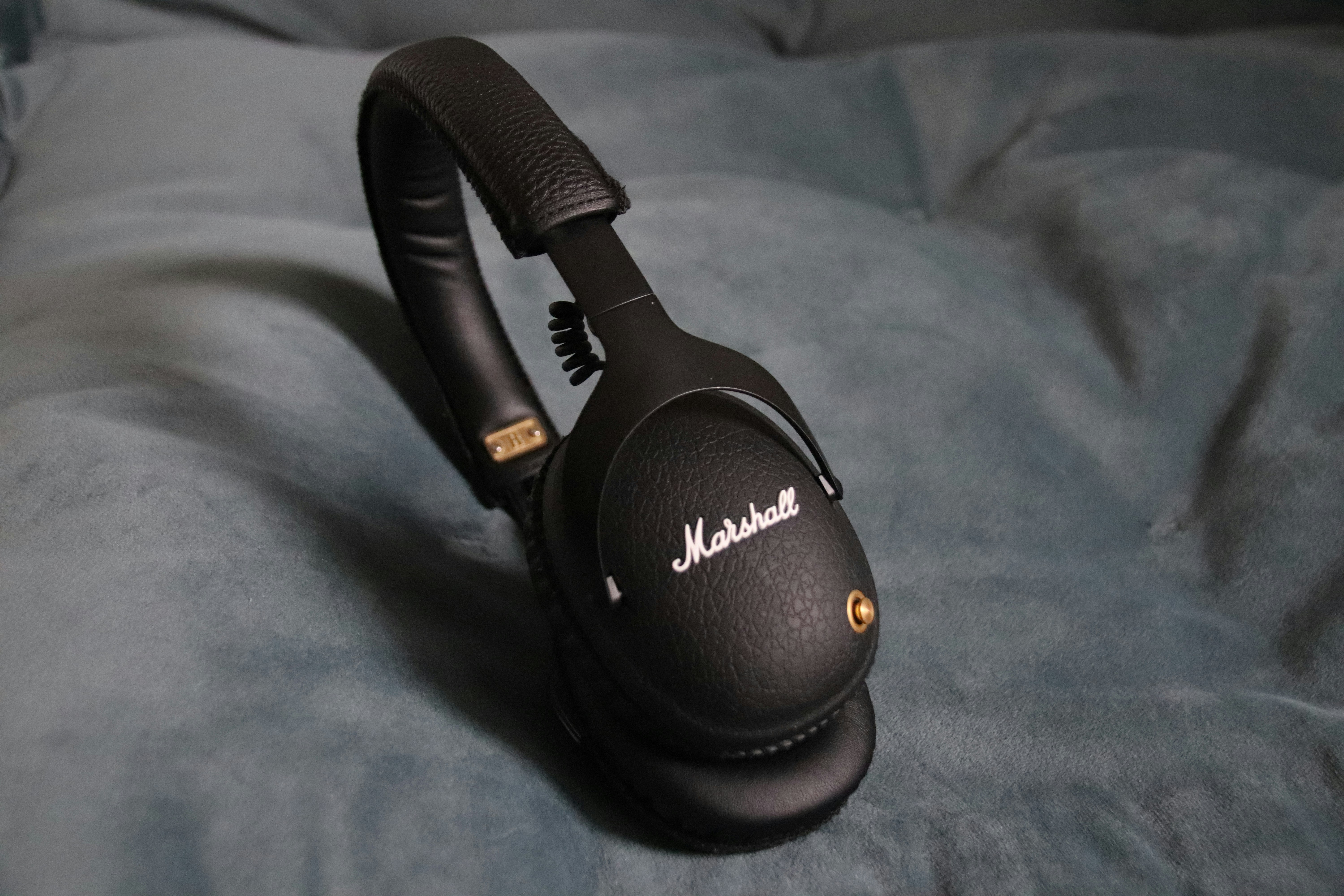 a close up of a pair of headphones on a bed