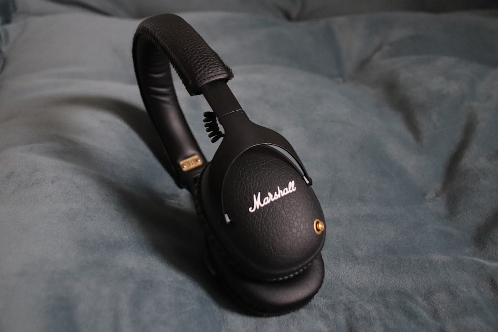 a close up of a pair of headphones on a bed