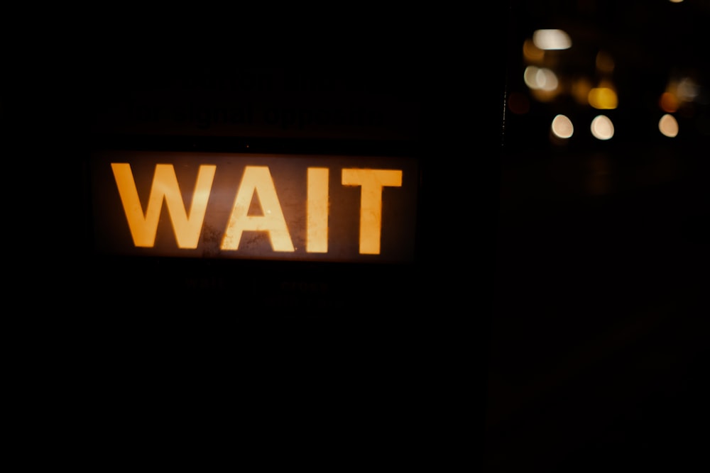 a close up of a street sign in the dark