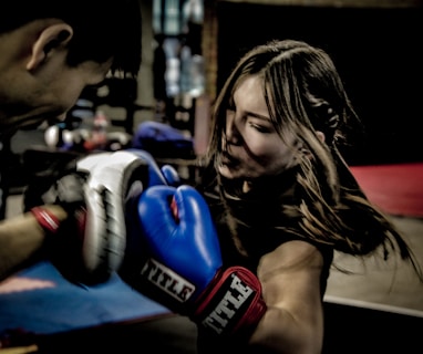 a man and a woman boxing in a gym