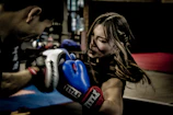 a man and a woman boxing in a gym