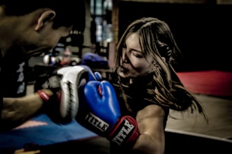 a man and a woman boxing in a gym
