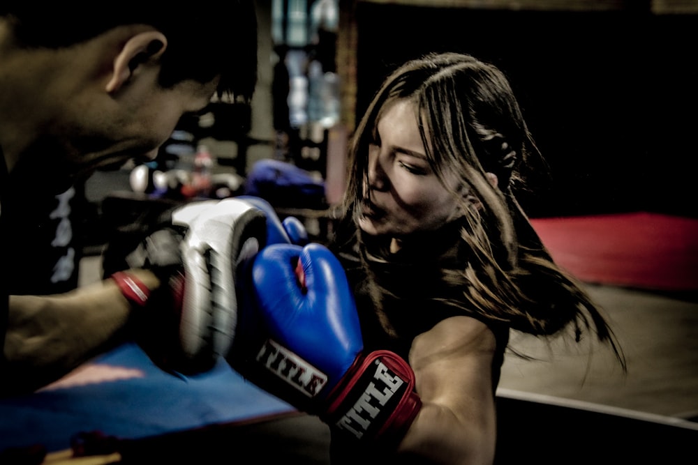 a man and a woman boxing in a gym
