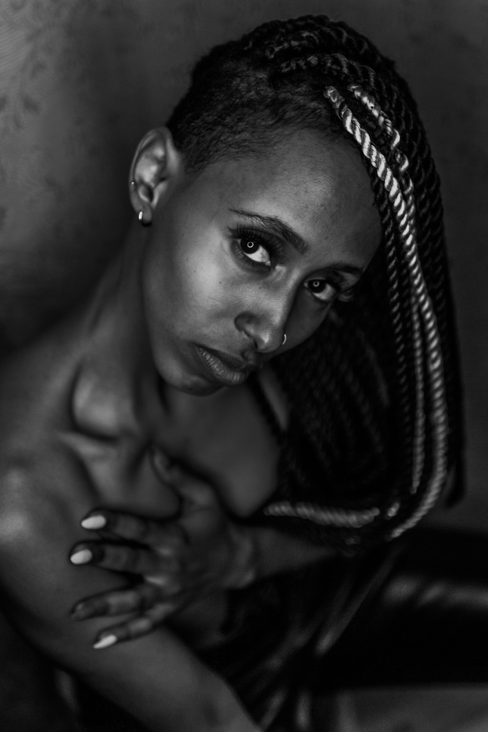a black and white photo of a woman with braids