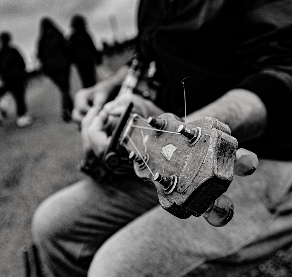 a black and white photo of a man holding a skateboard