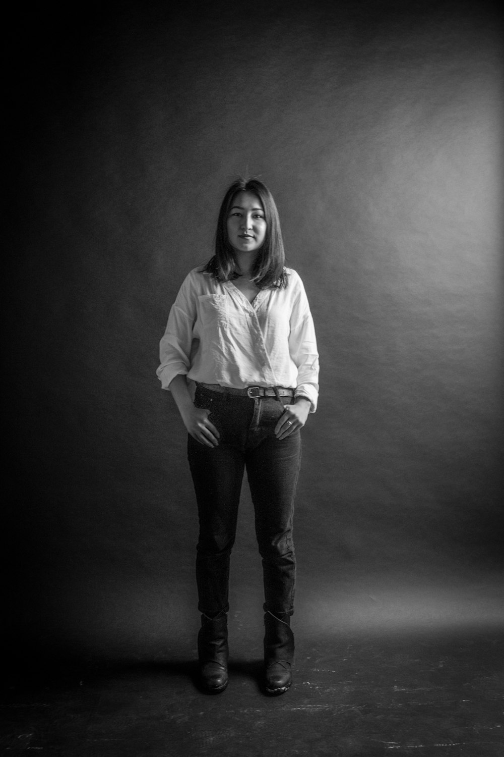 a woman standing in a black and white photo