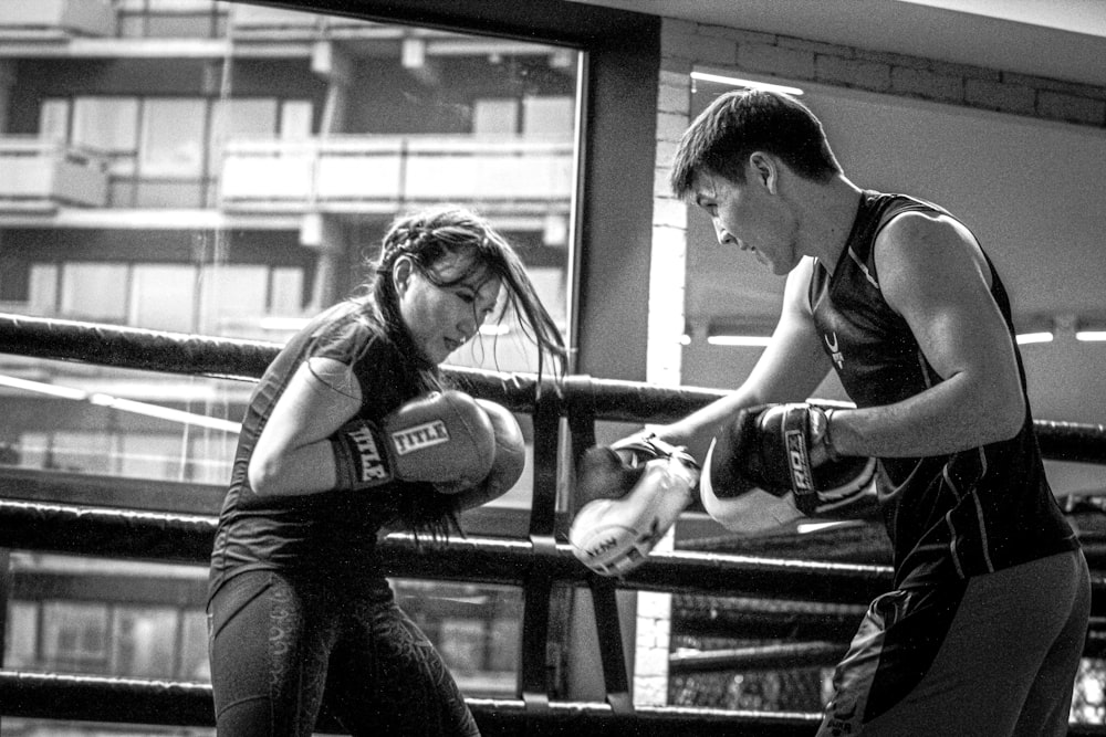 a couple of women standing next to each other in a boxing ring