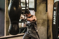 a man is practicing boxing in a gym