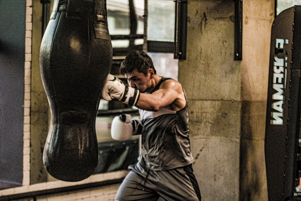 a man is practicing boxing in a gym