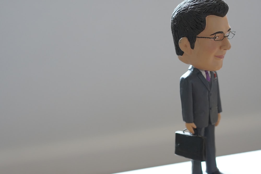 a bobble head of a man in a suit and tie