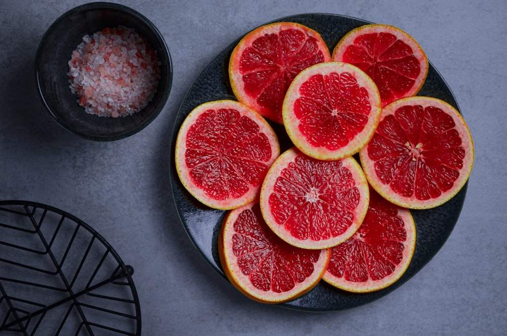 a plate of grapefruit cut up on a table