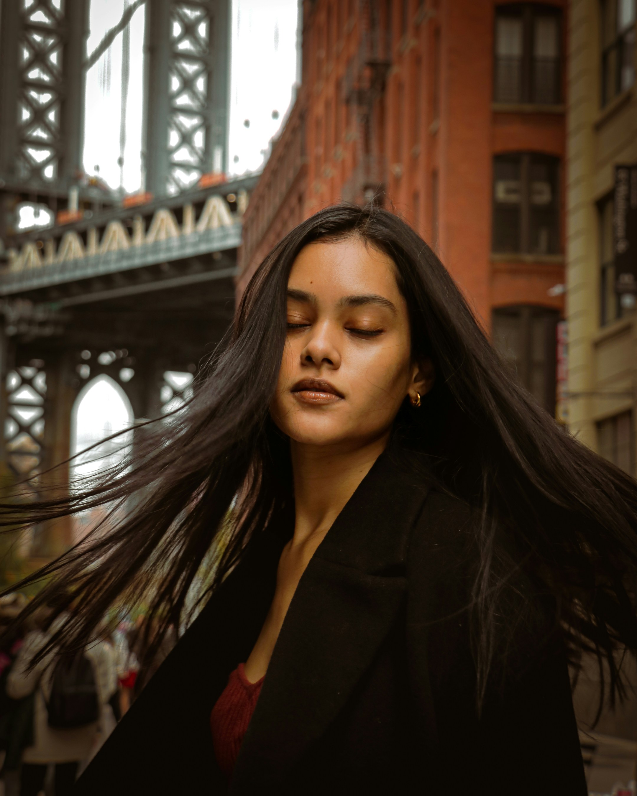 A woman with long hair standing in front of a bridge photo – Free New ...