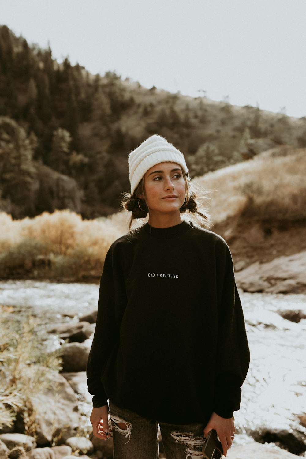 a woman standing in front of a river