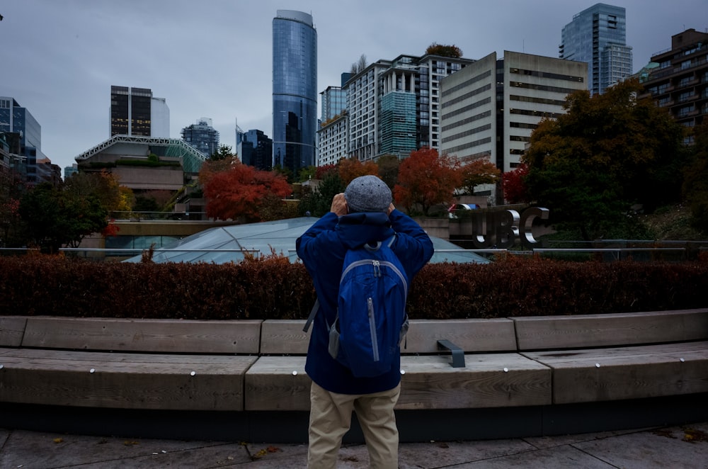 a person taking a picture of a city skyline