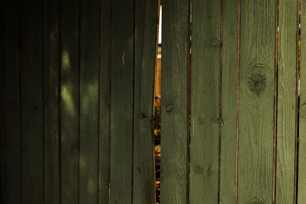 a close up of a wooden fence with a stop sign