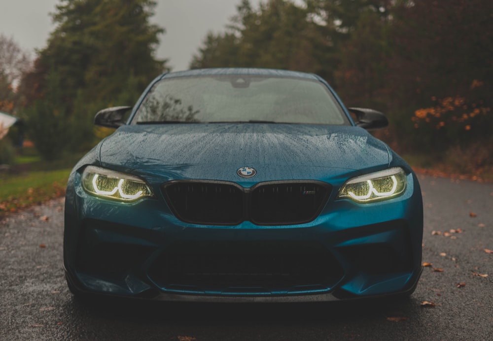 a blue car parked on the side of a road