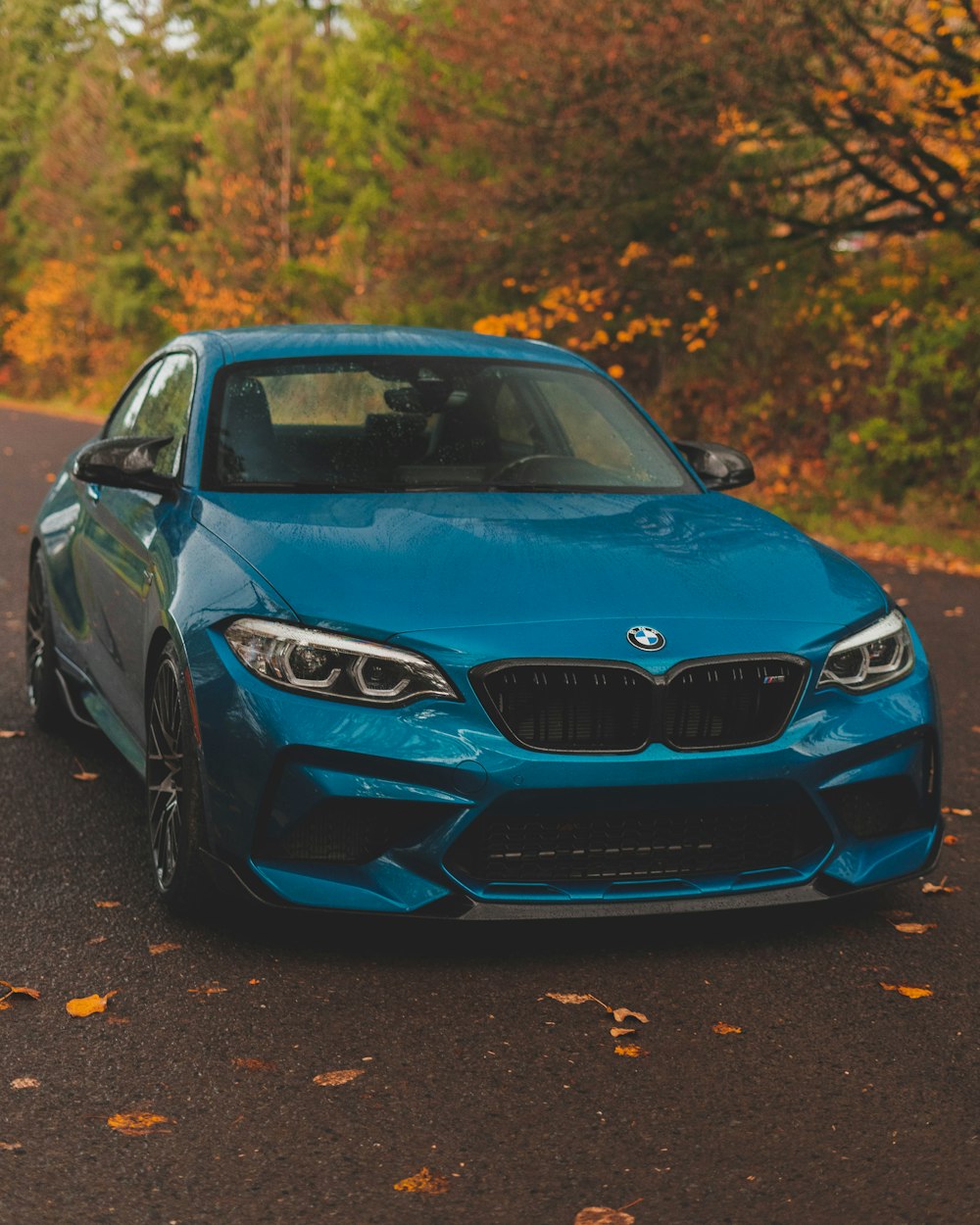 a blue car parked on the side of the road