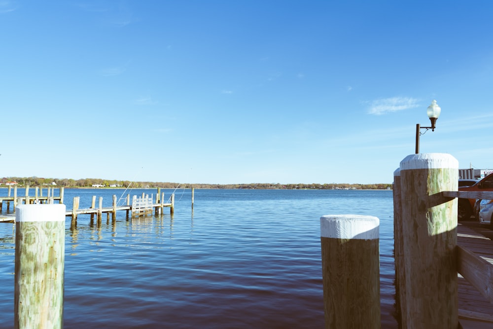 a dock with a lamp post and some water