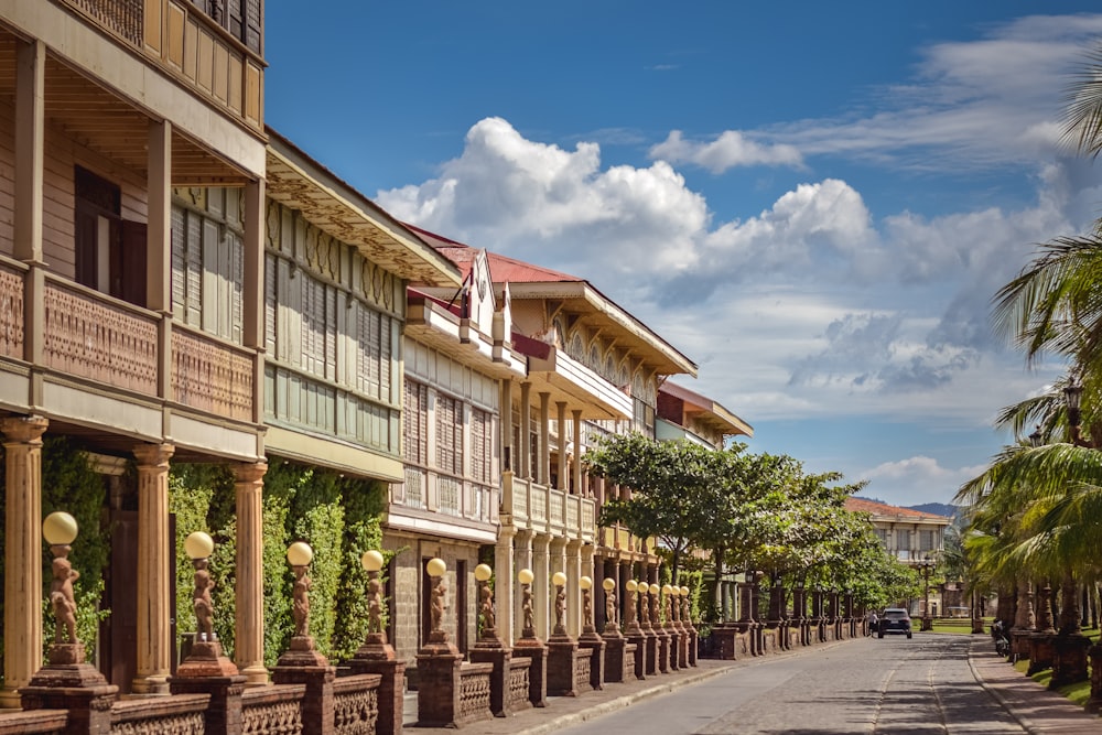 a street lined with wooden buildings and palm trees