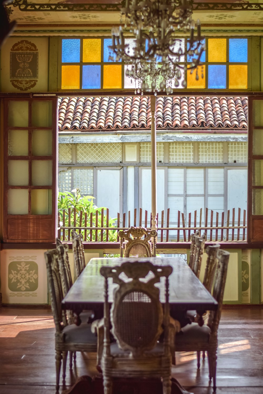 a dining room table with chairs and a chandelier